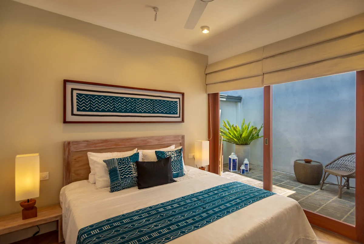 Indigo Suite King Bed with Blue Batik Textiles and Courtyard Patio